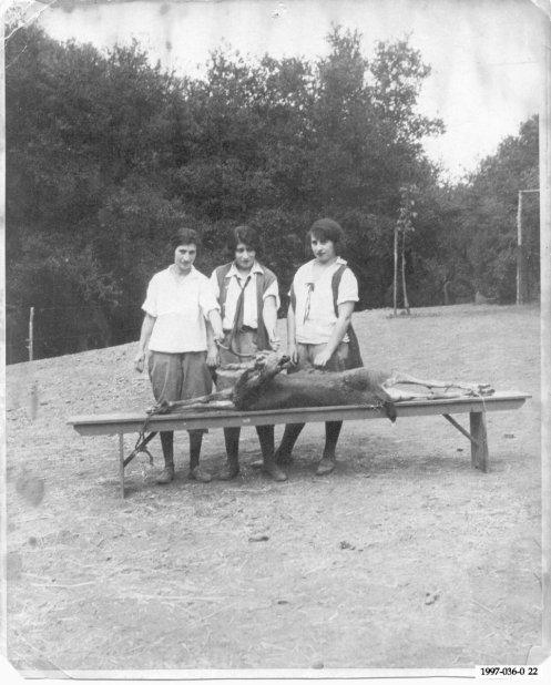 A family friend and two of my father's aunts prepare to skin a deer in 1920.